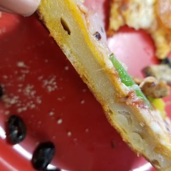 Cicis Pizza - a hand holding a slice of pizza - Pizza Near Me - League City, Texas