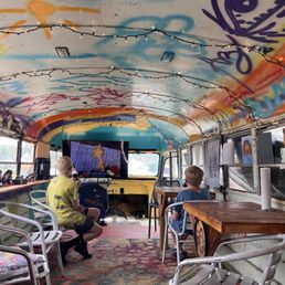 Inside the bus that you can go in while watching Looney Tunes with the chairs (it has air-conditioning)