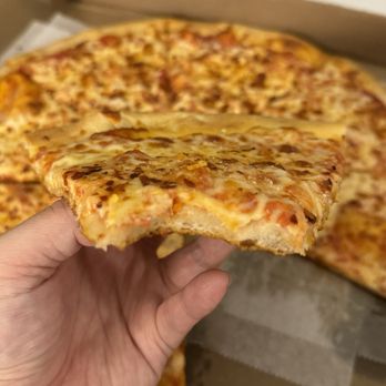 $1.50 Fresh Pizza - a hand holding a slice of pizza - Pizza Near Me - New York, New York $1.50 Fresh Pizza - a hand holding a slice of pizza - Pizza Near Me - New York, New York