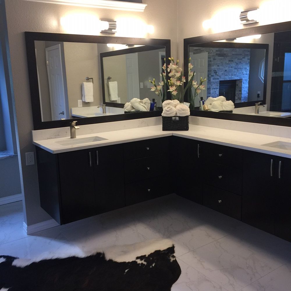 Custom built cabinets and mirrors, with marble tile. Stack stone fireplace in the background. Beautiful! Custom built cabinets and mirrors, with marble tile. Stack stone fireplace in the background. Beautiful!