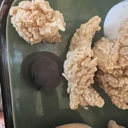Bush's Chicken - This is a pic of 'tenders' I received next to the tea lid for size reference.