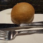 Photo of Oyster Bar - Las Vegas, NV, United States. Sourdough bread bun and place setting. Butter available. It's basically something to whet your appetite.