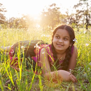 Heather Gallagher Photography - A young girl lays in the tall grass - Session Photography Near Me Heather Gallagher Photography - A young girl lays in the tall grass - Session Photography Near Me