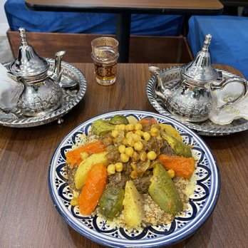 Moroccan Bites by Siham - Moroccan mint tea in the silver pots. Very comforting and delicious. Beef stew with couscous. - Moroccan Near Me - Queens, New York