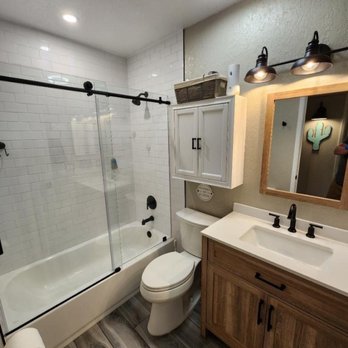 Weeks Contracting - a bathroom with a shower, toilet and sink - General Contractors Near Me Weeks Contracting - a bathroom with a shower, toilet and sink - General Contractors Near Me