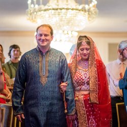 Bride dressed with Indian gown crying while walking down the aisle at the Pfister Hotel in Milwaukee, WI.