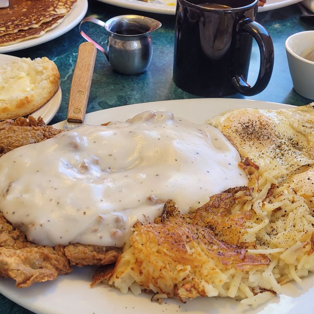 Chicken fried steak with sausage gravey, eggs, and hash browns with wonderful biscuit