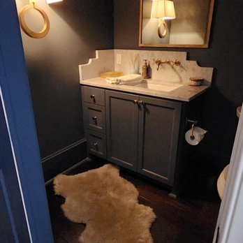 MILIEU - a bathroom with a sheepskin rug on the floor - Interior Design Near Me MILIEU - a bathroom with a sheepskin rug on the floor - Interior Design Near Me