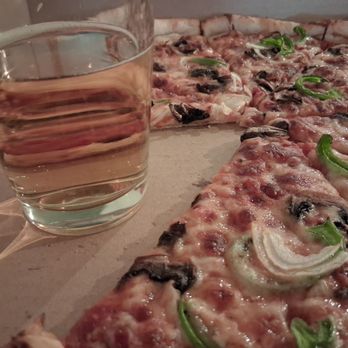 Ladybird Pizza - Pizza up close, with a pint of Estrella Jalisco from the Hitching Post. - Pizza Near Me - Bisbee, Arizona Ladybird Pizza - Pizza up close, with a pint of Estrella Jalisco from the Hitching Post. - Pizza Near Me - Bisbee, Arizona