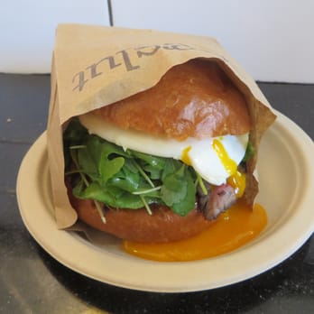 Eggslut - Before - Gaucho (seared wagyu tri-tip steak, chimichurri, red onions and seasoned arugula topped with an over medium egg, in a warm brioche) - Breakfast & Brunch Near Me - Los Angeles, California