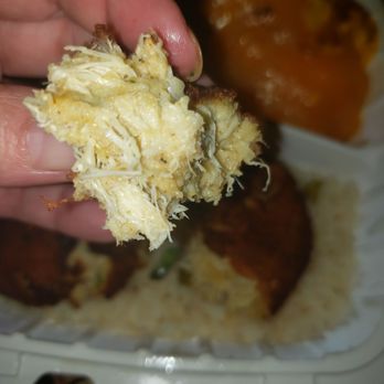 Carolina Kitchen - a hand holding a piece of food - Soul Food Near Me - Brandywine, Maryland