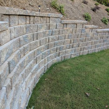 Graceful Gardens - a stone retaining wall in a park - Landscape Architects or Designers Near Me
