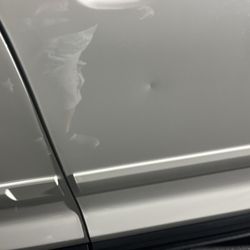Paintless Dent Doctor - Before but never fixed properly , he put touch up paint to cover the dent