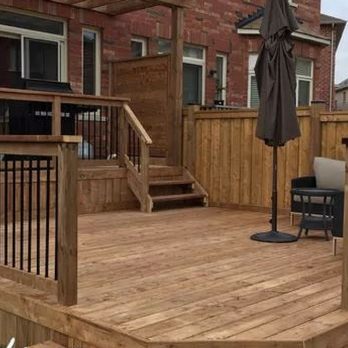 Newman Decks - a wooden deck with an umbrella - Decks & Railing Near Me Newman Decks - a wooden deck with an umbrella - Decks & Railing Near Me