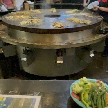 HuHot Mongolian Grill - a group of people preparing food - Mongolian Near Me - Rapid City, South Dakota
