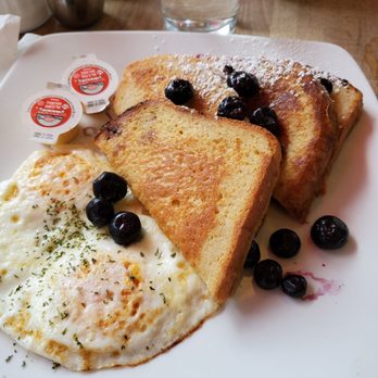 Red Umbrella Cafe - My $8 French toast plays $2 for that tiny amount of blueberries. Oh and the eggs that I ordered poached... And clearly are no. $250 an egg. - Breakfast & Brunch Near Me - Vancouver, British Columbia