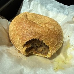 Beef curry bun with a bite out because it was fresh out of the oven Beef curry bun with a bite out because it was fresh out of the oven
