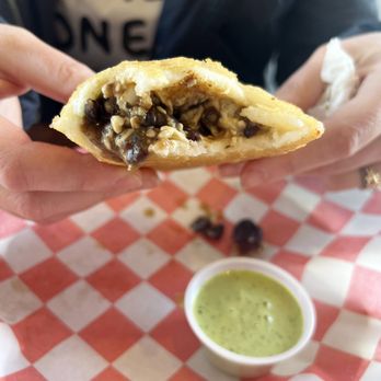 Amaizing Arepa Bar - Empanada with cilantro garlic sauce. Beans and cheese inside. - Venezuelan Near Me - Saint Louis, Missouri Amaizing Arepa Bar - Empanada with cilantro garlic sauce. Beans and cheese inside. - Venezuelan Near Me - Saint Louis, Missouri