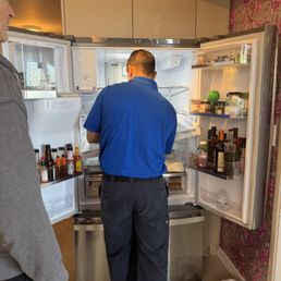 Luis trying to fix the refrigerator