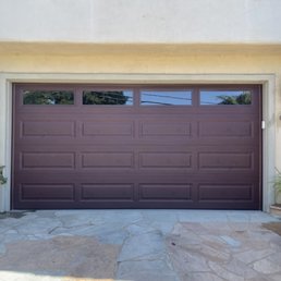 Exterior outside entrance of Master Express Garage Doors - New sectional garage door with dark wood finish - Simi Valley, California Exterior outside entrance of Master Express Garage Doors - New sectional garage door with dark wood finish - Simi Valley, California
