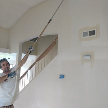 Zac Paulk Construction - a man holding a paint roller and a paint bucket - General Contractors Near Me Zac Paulk Construction - a man holding a paint roller and a paint bucket - General Contractors Near Me