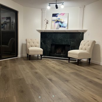 Sea Delta Construction - a living room with a fireplace - Flooring Near Me Sea Delta Construction - a living room with a fireplace - Flooring Near Me
