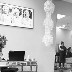 A shot of our front desk and a stylist working in the background.