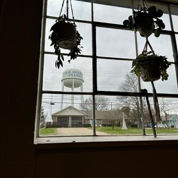Dose - a view of a water tower through a window - Coffee & Tea Near Me - Nashville, Tennessee