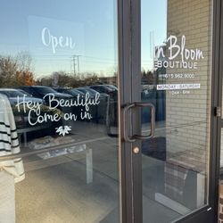 In Bloom Boutique - Hours posted and the sign saying open yet the doors are locked.