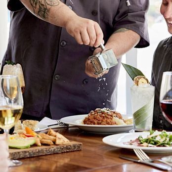 Juliet Social  - a chef pouring wine over a plate of food - Italian Near Me - Georgetown, Texas