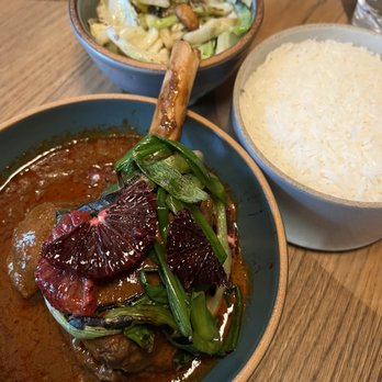 Nari - Gaeng Massaman Gae (Lamb Shank - front), Caramelized Fish Sauce Cabbage (back) - Thai Near Me - San Francisco, California