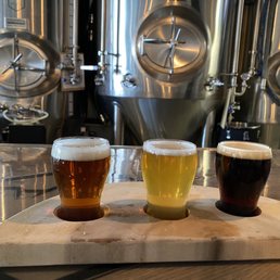 three glasses of beer on a cutting board three glasses of beer on a cutting board
