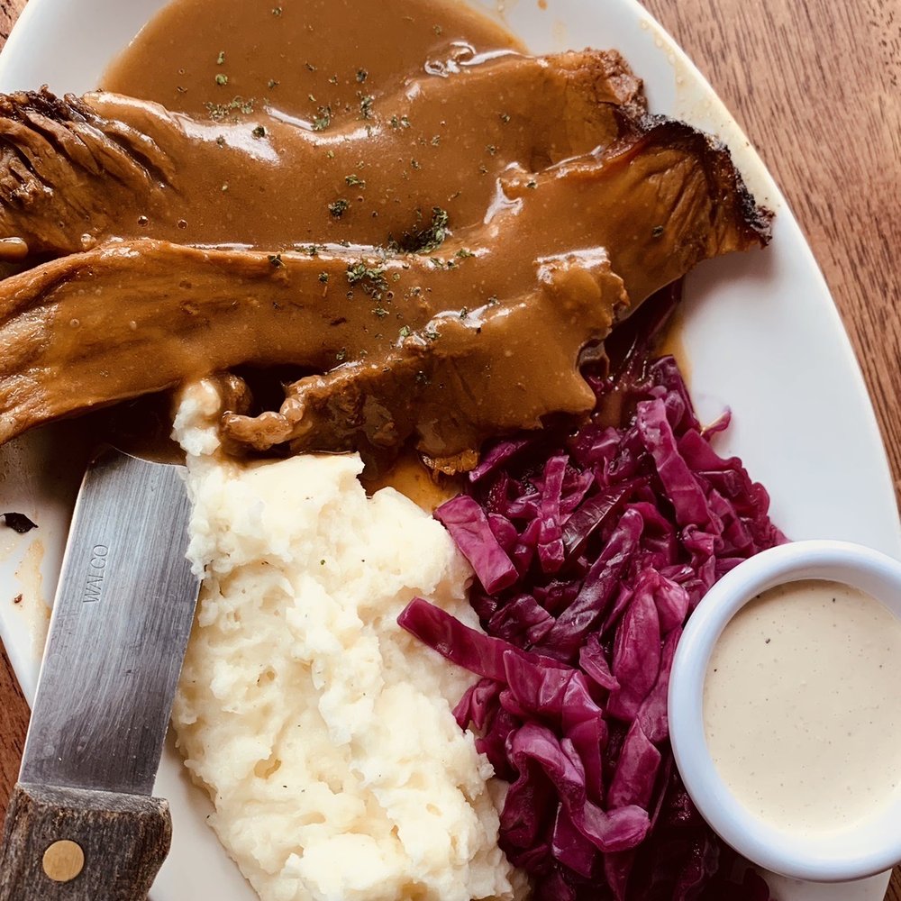 a plate of meat, mashed potatoes and gravy a plate of meat, mashed potatoes and gravy