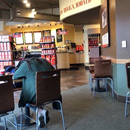 a man sitting at a table in a coffee shop a man sitting at a table in a coffee shop