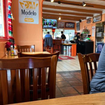 Los Amigos - a woman sitting at a table in a restaurant - Mexican Near Me - Pacific Grove, California Los Amigos - a woman sitting at a table in a restaurant - Mexican Near Me - Pacific Grove, California
