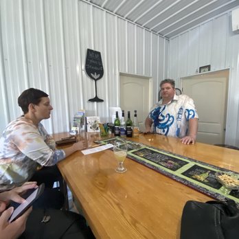 Silver Waters Wine - two men sitting at a wooden table - Wineries Near Me - Sodus, New York Silver Waters Wine - two men sitting at a wooden table - Wineries Near Me - Sodus, New York