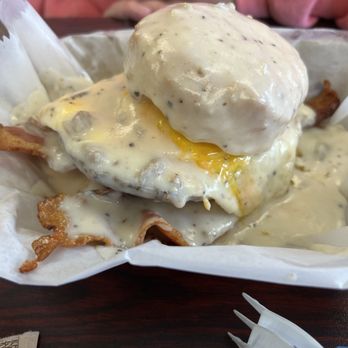 Biskit NV - Pork Savage= one huge biscuit, 2 or 3 slices of bacon, 2 large sausage patties, cheddar cheese and gravy. - Breakfast & Brunch Near Me - Cleveland, Tennessee