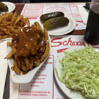 Schwartz's - Poutine, fries, Cole slaw, and their famous pickles - Delis Near Me - Montreal, Quebec