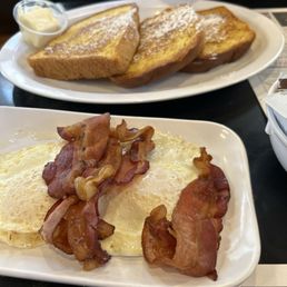 French toast over easy eggs and bacon