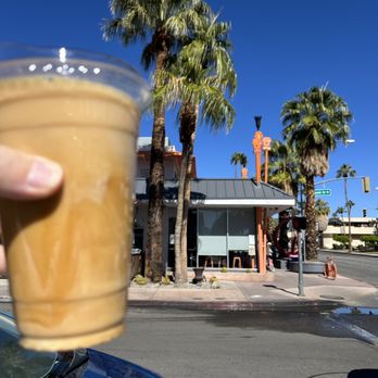Ernest Coffee - Iced Americano with Ernest (the coffee house) in the background. - Coffee & Tea Near Me - Palm Springs, California Ernest Coffee - Iced Americano with Ernest (the coffee house) in the background. - Coffee & Tea Near Me - Palm Springs, California