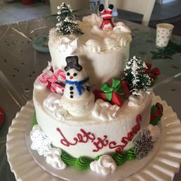 a frosted cake with a snowman on top a frosted cake with a snowman on top