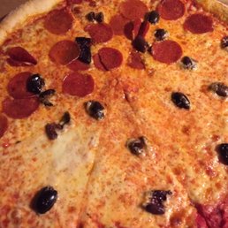 This is a large pizza half pepperoni all black olives where are the olives? This is a large pizza half pepperoni all black olives where are the olives?