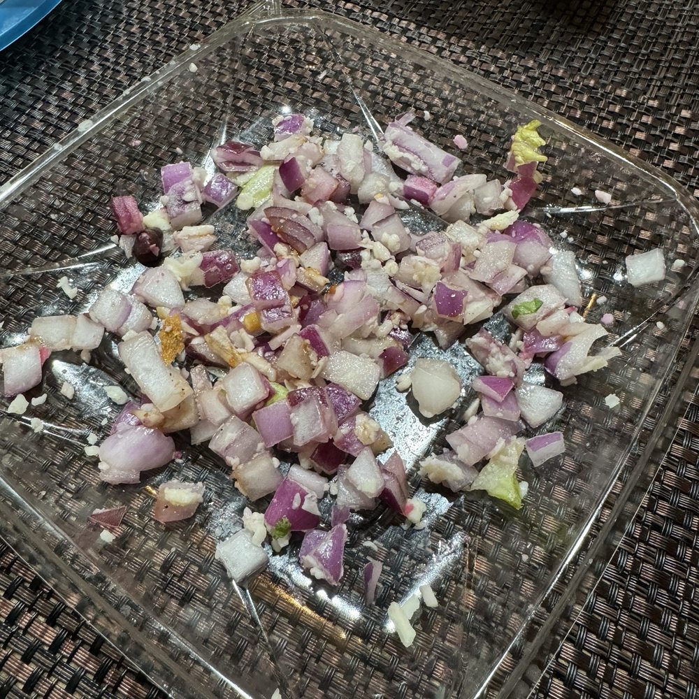 At least a half of an onion! I said please  no onions. Ruined.