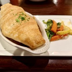 The Auld Shebeen - Steak & Mushroom Ale Pie $17.95 Slow cooked IPA marinated beef tips and vegs in a rich brown sauce topped with a puff pastry.