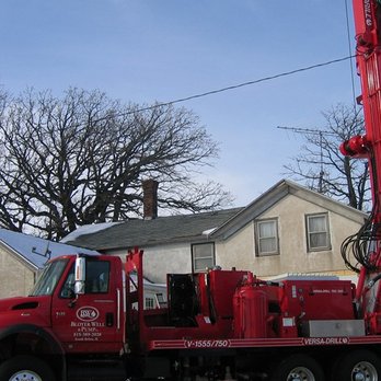 Bloyer Well & Pump - a large red truck parked in front of a house - General Contractors Near Me - South Beloit, Illinois Bloyer Well & Pump - a large red truck parked in front of a house - General Contractors Near Me - South Beloit, Illinois