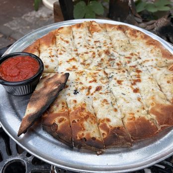 Kaos Pizzeria - Cheesy Breadsticks with grilled garlic hidden below - Pizza Near Me - Denver, Colorado