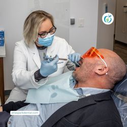 Atlas Park Dental - Emergency dentist providing urgent dental care to a patient at Atlas Park Dental in Glendale, NY