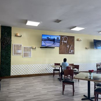 Jenny’s Caribbean Bistro - a man sitting at a table - Desserts Near Me - West Park, Florida Jenny’s Caribbean Bistro - a man sitting at a table - Desserts Near Me - West Park, Florida