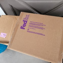 FedEx Office Print & Ship Center - Packages for the business next door left outside our door.
