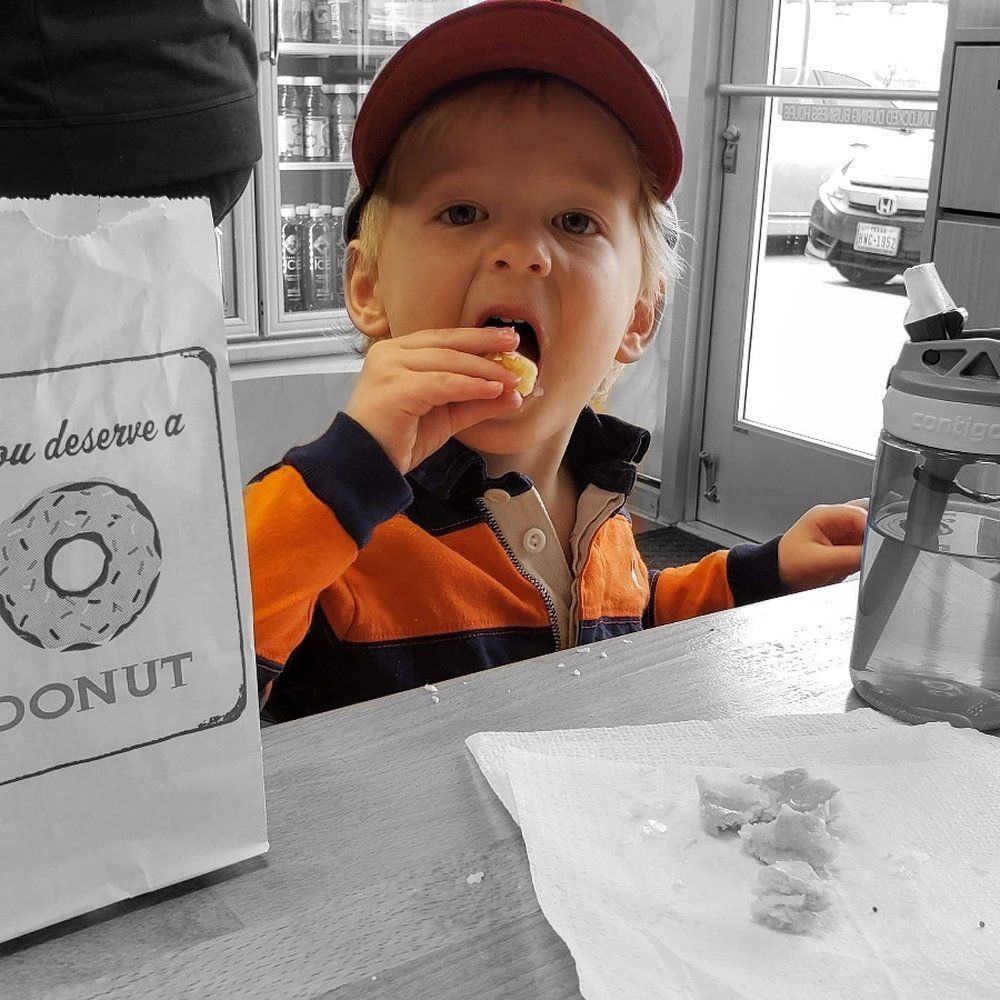 Happy kid eating donuts